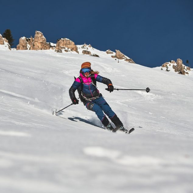 Martina Valmassoi ski touring at sunrise above Misurina, on the ridge between Misurina and Val Popena. Views over Punta Sorapiss, Cadini di Misurina and Tre Cime di Lavaredo.